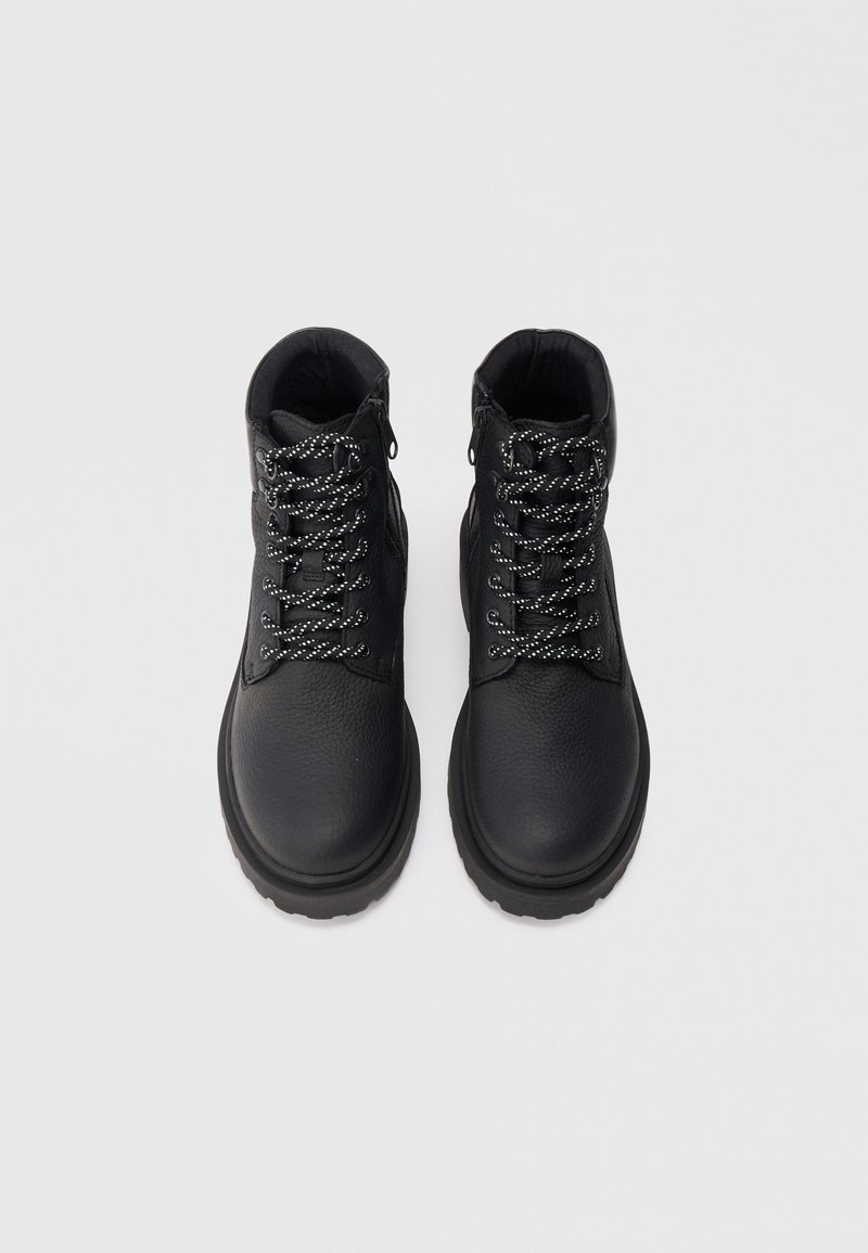 Black leather boots with a textured surface, featuring black and white laces, a padded collar, and a thick, durable sole.