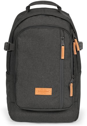 Black fabric backpack with a smooth texture, featuring a front pocket, zip closures, and orange leather accents. Padded straps and a top handle.
