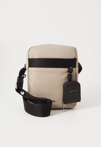 Borsa a tracolla beige con una tracolla nera, dotata di una banda orizzontale nera frontale e di una piccola tasca con zip nera attaccata. Tessuto dal tocco liscio.