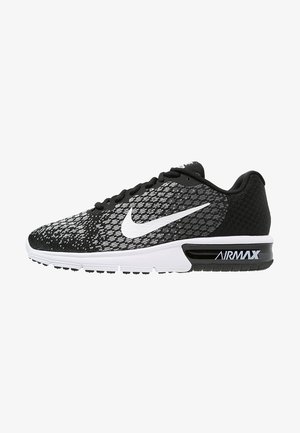 Chaussure de course Nike Air Max noir et blanc avec empeigne en mesh à motifs, semelle à coussin d'air visible et logo Nike swoosh blanc.