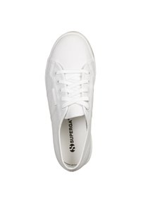 White canvas sneaker with a round toe, lace-up front, textured upper, and logo detail on the insole. Minimalistic design, clean lines.
