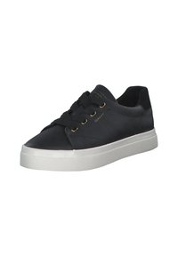 Black leather sneaker with rounded toe, gold eyelets, and black laces. Features a white rubber sole with textured grip pattern.