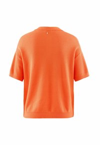 Pull en tricot orange à manches courtes avec une coupe ample. Présente un motif texturé subtil et un ourlet côtelé. Petite accentuation au niveau de l'encolure arrière.