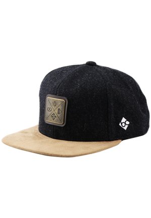 Black and tan snapback cap with beige suede brim, front metal patch featuring four icons, and small white logo on side panel.