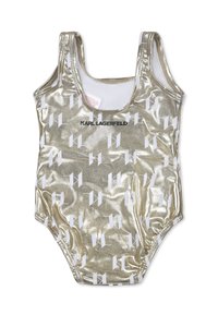 Maillot de bain une pièce métallisé dor é avec une finition brillante, imprimé logo blanc, encolure scoop et bretelles, avec des détails froncés au niveau des ouvertures de jambes.