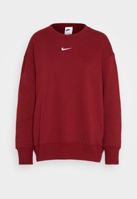 Sudadera roja de mezcla de algodón, con cuello redondo, hombros caídos, puños de canalé y un pequeño logo blanco de Nike en el pecho.