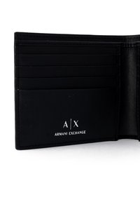 Black leather wallet featuring multiple card slots, embossed logo "A/X ARMANI EXCHANGE," and clean, smooth texture. Interior is minimalistic.