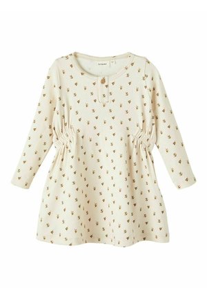 Kremfarvet kjole lavet af blødt stof med blomsterprint, lange ærmer, rund halsudskæring og samlinger i siderne.