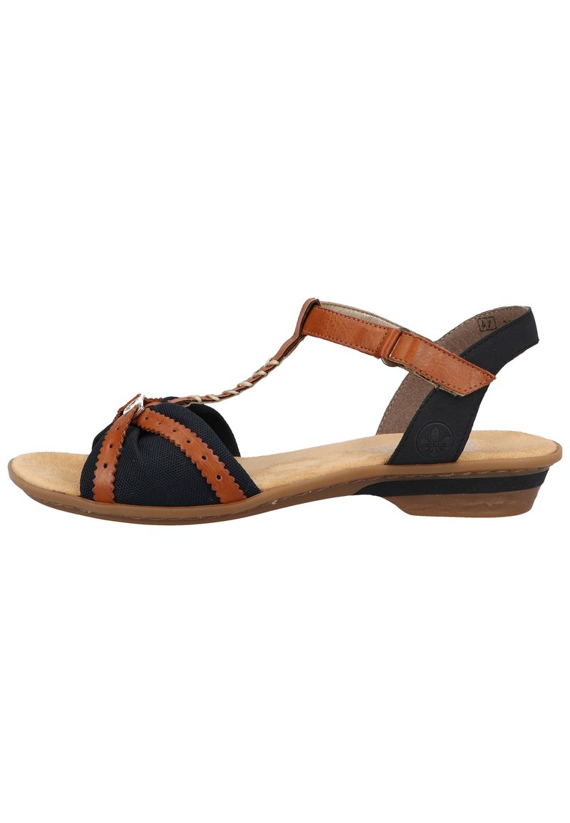 Women's sandal with a black fabric upper, brown leather accents, T-strap design, textured footbed, and a low wedge heel.