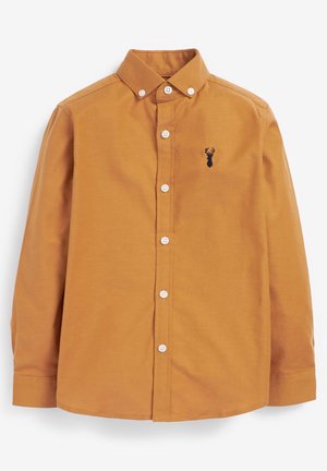 Chemise jaune moutarde à manches longues boutonnée avec col boutonné et petit logo noir tête de cerf sur la poitrine gauche.