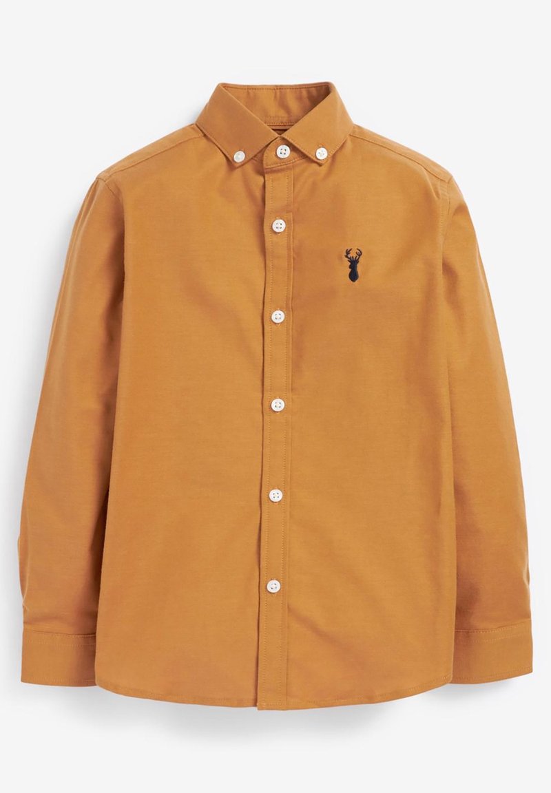 Chemise jaune moutarde à manches longues boutonnée avec col boutonné et petit logo noir tête de cerf sur la poitrine gauche.