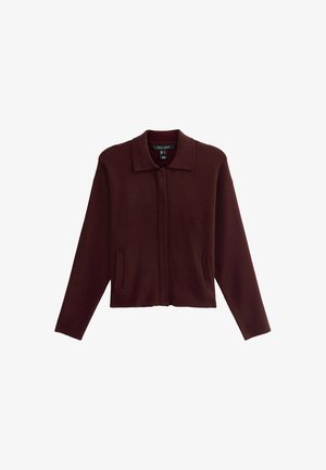 Burgundy wool blend jacket with a collar, long sleeves, and side pockets. Minimalist design with a cropped silhouette and soft texture.