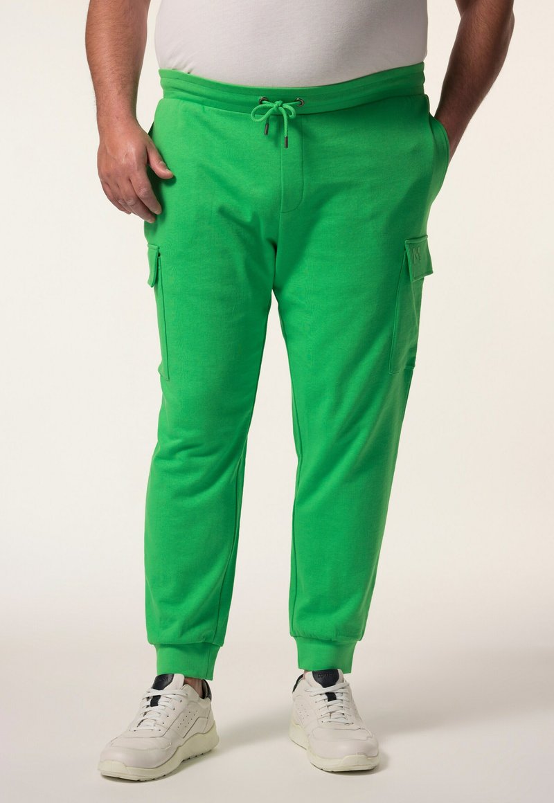 Groene joggingbroek met een trekkoord in de taille, zijzakken en geribbelde boorden. Gemaakt van zacht materiaal met een gladde textuur.