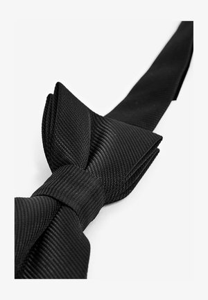 Schwarze Fliege aus strukturiertem Stoff, mit einem auffälligen Knoten und einem langen Band. Zeigt ein dezentes Rippenmuster.