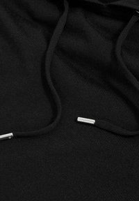 Hanorac negru din material moale. Are șnururi cu capete metalice și o suprafață texturată. Design minimalist, fără modele.