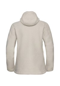 Veste en polaire couleur écrue avec une surface texturée, une capuche ajustée et des manches raglan. Détails de coutures le long des bords.