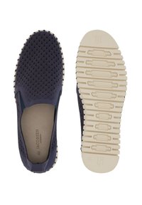 Navy blue slip-on shoes with a textured upper, featuring a wave pattern. The outsole is light cream with a ridged design for grip.