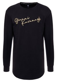 Dlouhý rukáv černého trička vyrobeného z bavlny s zlatým kurzívním logem "Gianni Kavanagh" napříč hrudníkem. Kulatý výstřih, uvolněný střih.