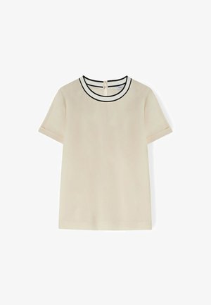 Kurzarmtop aus beigefarbenem Stoff, mit einem runden Halsausschnitt und schwarzem Besatz sowie einem keyhole-Verschluss auf der Rückseite. Glatte Textur mit minimalistischem Design.