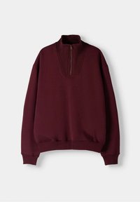 Sudadera granate con cuello alto acanalado y diseño con cremallera hasta la mitad. Textura suave, ajuste holgado y puños acanalados en las mangas y el dobladillo inferior.