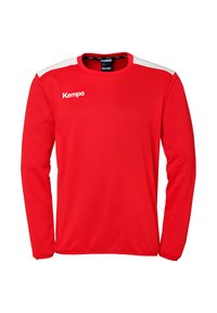 Rode shirt met lange mouwen van zacht materiaal, met witte schouderaccenten en een Kempa-logo aan de voorkant links. Gladde textuur.