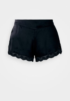 Pantalones cortos de satén negro con ribete de encaje, que presentan un borde ondulado y una textura suave. Diseñados con una cinturilla ajustada para un look a medida.
