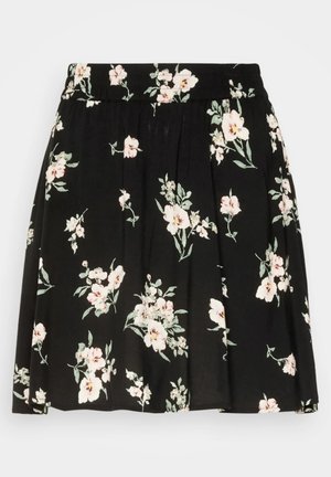 Jupe noire avec imprimé floral blanc et rose et feuilles vertes, dotée d'une taille froncée et de plis doux.