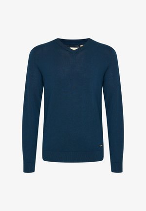 Mörkblå V-ringad tröja i mjukt stickat tyg. Har långa ärmar, ribbade muddar och en liten logotypdetalj vid fållen.