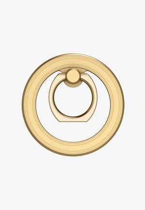 Zlatý kruhový úchyt s hladkým povrchem a vyvýšeným středem. Má texturovaný vnější okraj a centrální otočný bod pro snadné použití.