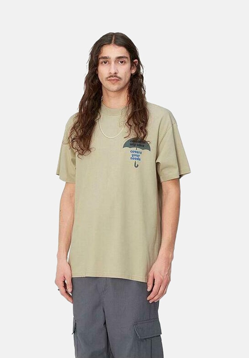 Camiseta de algodón beige de manga corta, con un gráfico de un paraguas y texto. Cuello redondo, corte relajado, diseño sin costuras, sin logotipos visibles.
