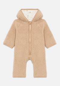 Beige, fluffy barnejumpsuit med hette, frontlås og mønstret innfelling med luftballonger og stjerner.