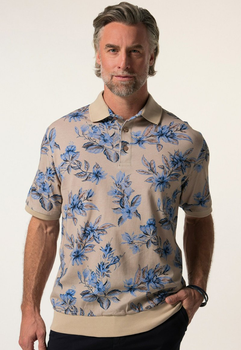 Květinová polo košile s béžovým podkladem a modrými květinovými vzory, krátkými rukávy a kontrastním límcem se třemi knoflíky.