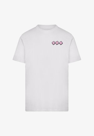 White cotton T-shirt with short sleeves. Features a small pink floral design on the left chest area. Rounded neckline.