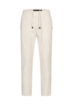 Lys beige snørebåndsbukser med et tekstureret stofmønster, elastisk talje og en tætsiddende design med sidelommer.