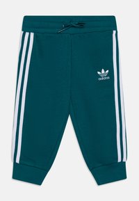 Pantaloni della tuta teal con strisce laterali bianche, vita elastica con cordino e piccolo logo Adidas bianco sul davanti. Tessuto morbido.