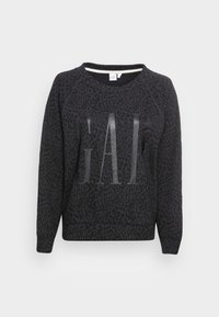 Sweat-shirt noir avec un imprimé léopard texturé et un grand logo "GAP" brillant sur le devant. Présente des manches raglan et un col côtelé.