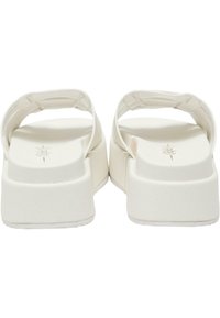 Sandales blanches à semelle plate avec deux sangles ajustables. Surface lisse avec une finition mate. Le design de talon épais offre stabilité et confort.