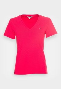 V-hals t-shirt i klar pink. Korte ærmer, lavet af glat bomuldsstof. Har et lille logo på brystet.