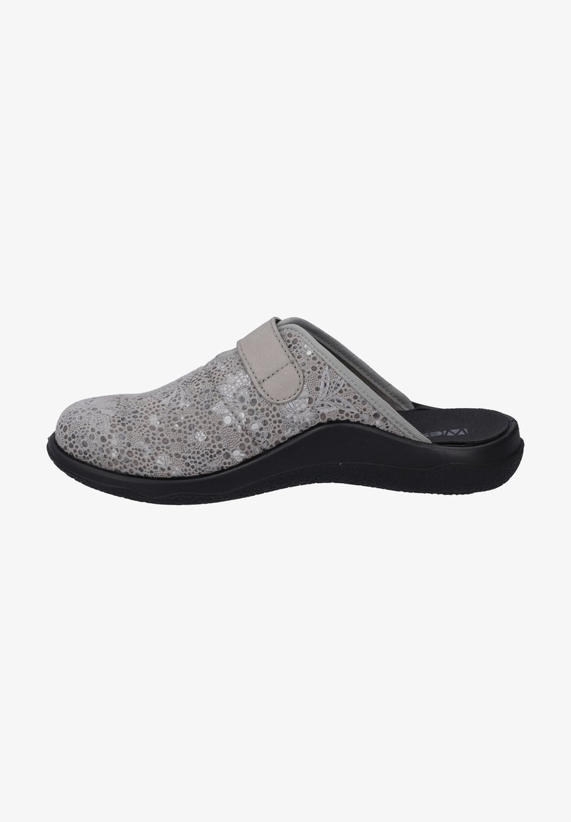 Gray slip-on shoe with a textured upper featuring a pattern of circles, adjustable strap, and a thick black sole for support.