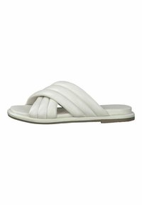 White slide sandals feature interwoven straps, smooth leather material, a flat sole, and subtle stitching detail on the straps.