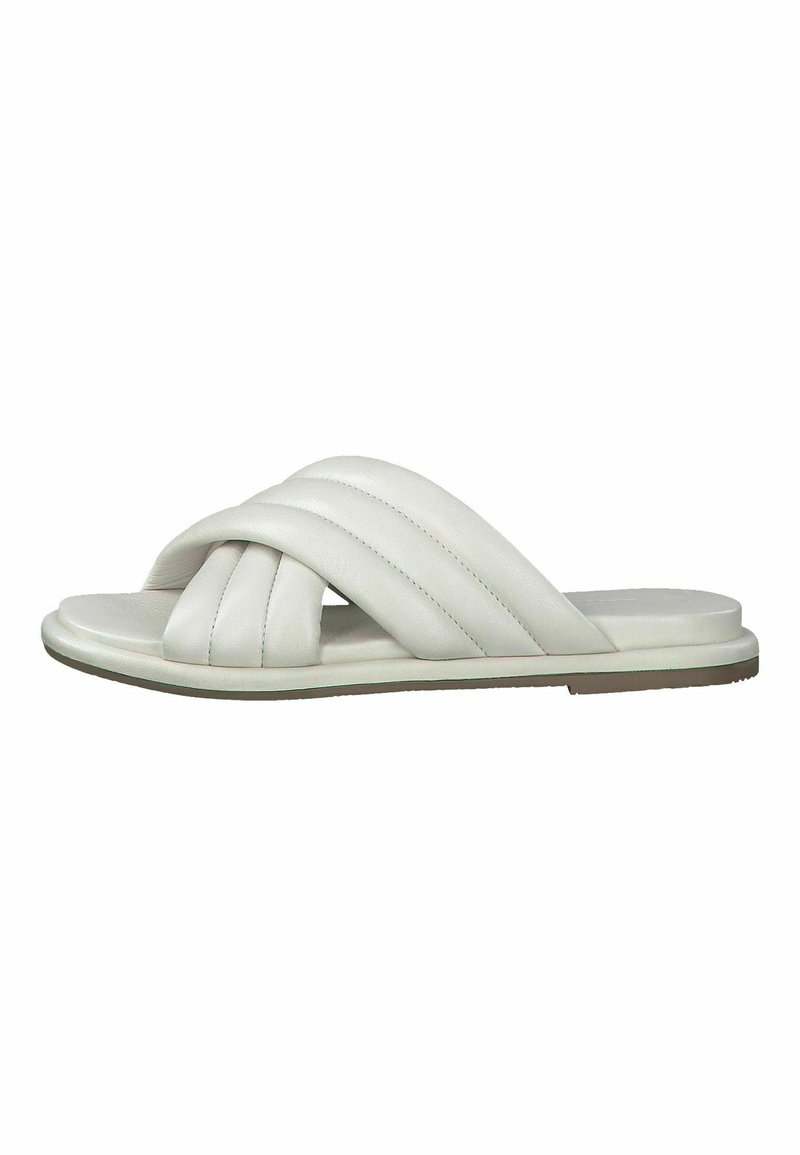 White slide sandals feature interwoven straps, smooth leather material, a flat sole, and subtle stitching detail on the straps.