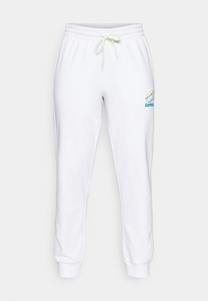 Valged puuvillased spordipüksid elastse vöökoha, reguleeritava nööriga ja sinise ning vikerkaarevärvides logodetailiga vasakul reiel.