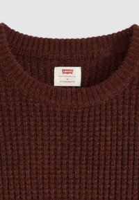 Brown ribbed knit Levi's sweater with round neckline and white size label showing "M Standard Fit."