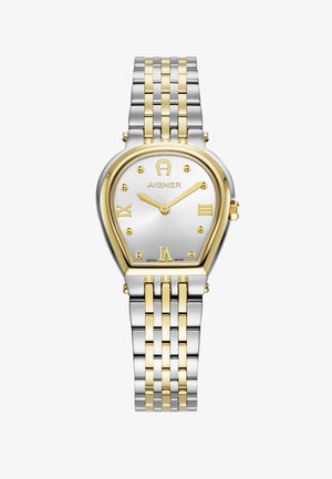 Reloj de metal dorado y plateado con forma de gota, esfera plateada, numerales romanos dorados y acabado texturizado. Cuenta con una pulsera bicolore.