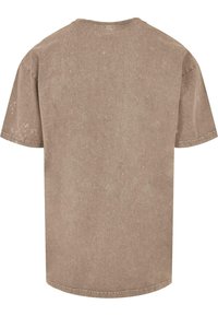 Short-sleeve, crew-neck t-shirt in a muted brown hue with a subtle texture and slight fading throughout. Features a straight hemline.