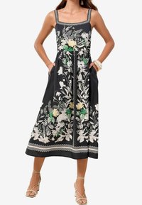 Czarna sukienka bez rękawów z kwiatowym haftem w zielonym i żółtym kolorze. Kwadratowy dekolt, dopasowana góra i boczne kieszenie. Rękaw wykończony białą lamówką.