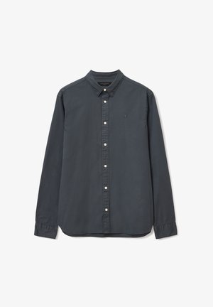 Tmavošedá dlhá rukávová košeľa vyrobená z bavlny s golierom na gombíky. Obsahuje predný panel s gombíkmi a malú vyšitú značku na hrudi.