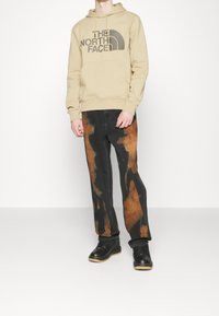 The North Face Jersey con capucha - sand