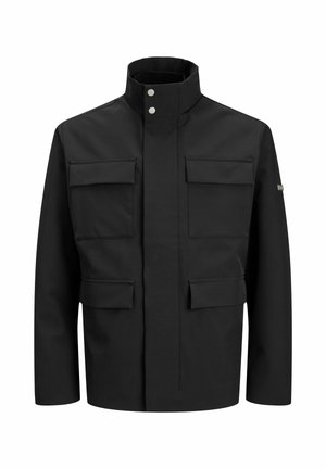 Must mustrakk, millel on kõrge krae, kaks suurt esikotti ja esine sulgemine. Valmistatud siledast kangast minimaalse aksessuaaride arvuga.