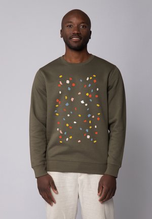 Olive green sweatshirt with a multicolor confetti pattern on the front. Ribbed cuffs and hem, made from soft textile material.